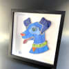 A playful stained-glass dog rendered in bright blues, green and orange brings
