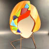 A playful, modern stained-glass face sculpture that doubles as a cheerful decorative
