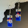 Deep blue rectangular glass drops catch the light like a slice of