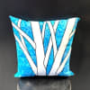 Bright blue marbled background and ribbon-like white stripes give this decorative pillow