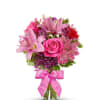 A lush cluster of pink lilies and a bright pink rose take