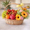 Fruit basket with flowers in a wicker basket