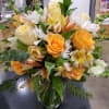 Bouquet of orange and white flowers in a clear glass vase