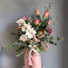 Creamy white phalaenopsis orchids and blush pink roses take center stage in