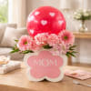 A cheerful Mother's Day flower arrangement that reads "MOM" on the box