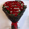 Bouquet of red roses with baby's breath wrapped in black paper