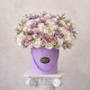 Pink and white roses with purple filler in a lavender hatbox