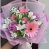 Pink and purple bouquet with gerbera daisies, roses, and white flowers