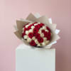 Bouquet of red and white roses wrapped in beige paper