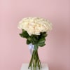 Bouquet of cream roses tied with a pale blue ribbon