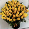 Yellow roses in a black hatbox with a butterfly accent
