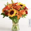 Orange and yellow mixed bouquet in a clear glass vase