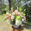 Soft pink roses, elegant lilies, white hydrangeas, and fresh green chrysanthemums are