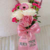 Pink and white prom corsage with roses, gerbera daisy, and a satin bow