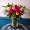 Lush red roses anchored at the center give this floral design a