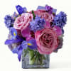 Roses orchids and more arranged in a modern glass cube style vase