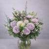 Soft lavender roses take center stage in this garden-style bouquet, a gentle