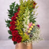 A vertical cluster of velvety red roses and crisp white snapdragons creates