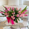 A full, balanced mix of pink tulips and spray roses paired with