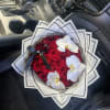 Bouquet of red roses with white orchids and black ribbon in a car seat