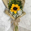 Sunflower bouquet wrapped in brown paper with a ribbon