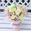 Bouquet of pale pink and cream roses in a white hatbox with a pink ribbon