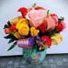 This cute fresh floral arrangement in keepsake container is great for many