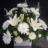 Pure white lilies and chrysanthemums come together in a calm, elegant arrangement