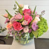 A vibrant, garden-inspired arrangement designed with rich color and natural movement. Featuring