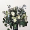 White roses and pale blue flowers in a black vase