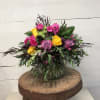 Mixed bouquet of pink and yellow roses in a glass vase