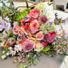 A lush, garden-style bouquet overflowing with soft pastels-Wrapped in Sunshine is a