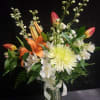 Bright orange lilies and soft pink tulips meet crisp white alstroemeria and