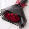 A stunning arrangement of 18 fresh red roses wrapped in elegant black