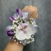 Orchid wrist corsage with deep purple tulips , white fillers and lavender