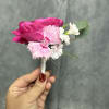 Hot-pink spray rose paired with pale pink and white carnations, compact hand-held