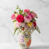 A charming pink arrangement designed in a traditional Mexican barro vase, Rosa