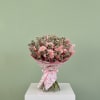 Pink Money features 50 pink roses, gerbera daisies, and $40 worth of