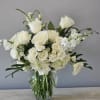 Beautiful modern vase of all white flowers including roses
