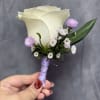 White rose  boutonni&egrave;re with lavender and white accents, wrapped in lavender