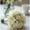 A timeless and elegant bouquet featuring creamy white roses, delicate lilies, and