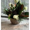 This centerpiece features roses, ranunculus, berries and seasonal foliage. Available in two