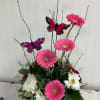 Bright pink gerbera daisies mingle with pastel accents in a playful spring-inspired