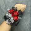 Red spray roses with black and silver ribbon and bead accents on