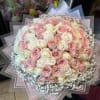 A lush dome of pale pink, blush and creamy white roses creates
