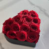Red roses arranged in a black heart-shaped box