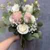 Soft white and blush roses with pale blue delphinium, lisianthus and baby's