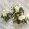 White rose boutonniere and matching wrist corsage with greenery and burlap ribbon