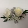 White rose boutonniere with silver ribbon and baby's breath