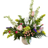 Mixed floral arrangement in a white textured vase with pink roses and white blooms